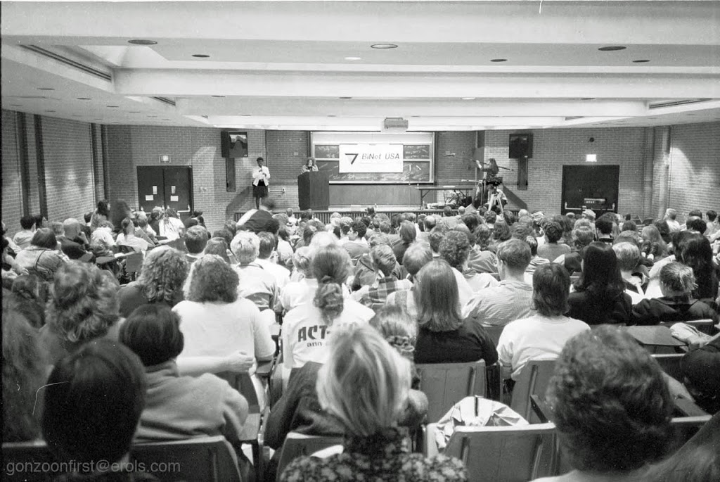A historical BiNet USA gathering with speakers and an audience
